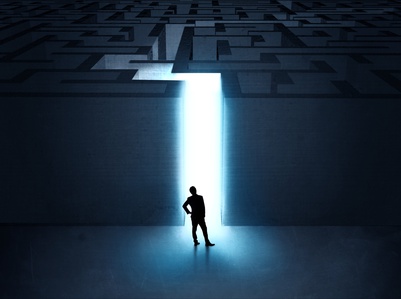 A businessman at the entrance to a maze